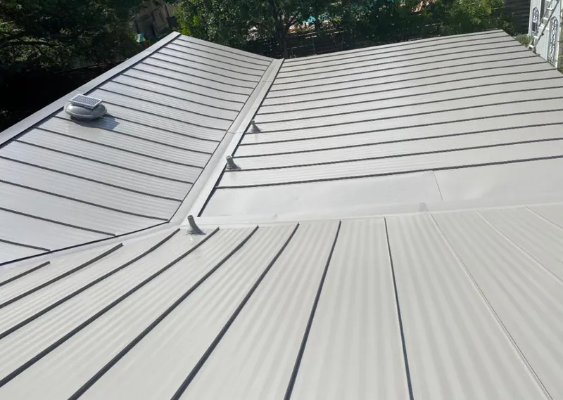 Solar attic fan installed on a metal roof for Roof Ventilation in North Kensington